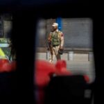 FILE PHOTO: An Indian security force personnel stands guard on