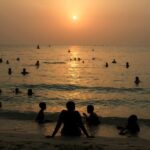 People enjoy the beach during the summer heat in Dubai