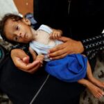 Palestinian mother Amira Muteir holds her five-month-old baby Ammar, whom