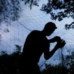 Ukrainian service member installs an anti-drone net at a position