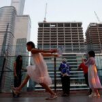 People visit a terrace of a shopping mall overlooking the