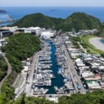 Fishing boats are docked inside a port, as Typhoon Podul