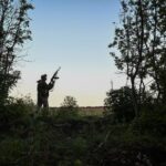 Ukrainian serviceman looks out for Russian combat drones near the