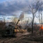 Ukrainian servicemen fires a self-propelled howitzer towards Russian troops in