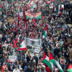 Demonstrators hold placards as they take part in the ‘Nationwide