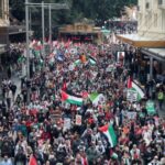 Demonstrators hold placards as they take part in the ‘Nationwide