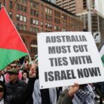 A demonstrators holds a placard as they take part in