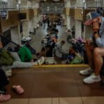 People take shelter inside a metro station during a Russian