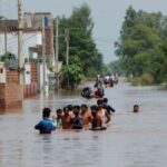 Monsoon rains and rising water levels in Qadirabad village near