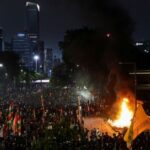 Protest outside Jakarta police headquarters, after a motorcycle taxi driver