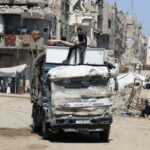 FILE PHOTO: Displaced Palestinians flee from one area to another