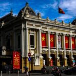 Vehicles drive past Hanoi Opera House, in Hanoi