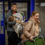 People take shelter inside a metro station during a Russian