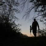 Ukrainian serviceman walks at a position near a front line