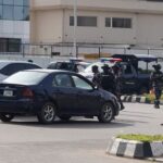 Members of Nigerian Police Force stop motorists near a protest