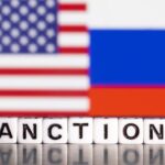Illustration shows letters arranged to read “Sanctions” in front of