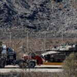 A truck transports a tank on the Israeli side of