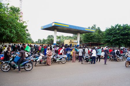FILE PHOTO: People gather at a petrol station due to