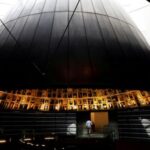FILE PHOTO: A security personnel walks at the Hall of