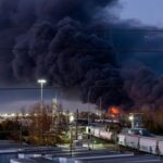 Smoke rises from the wreackage of a UPS MD-11 cargo