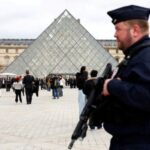 FILE PHOTO: A French CRS riot police officer patrols near the glass