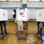 Voters fill in their ballots during voting for the U.S