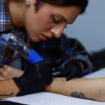 Tattoo artist Valeriia Stashenko makes a tattoo of ears of