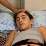 An Injured Palestinian boy Mohammed Helles, who suffered from a