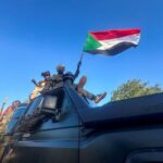Sudan’s army soldiers celebrate after entering Wad Madani