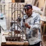 An Egyptian man works on-site at the Darb al-Labbana restoration