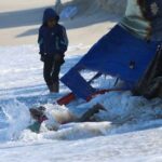 A child falls into the sea as Palestinians shelter in