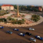 Cars move next to the presidential palace in Bissau