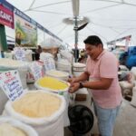 Alisson Farias, a flour seller reacts near his products at