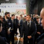 France’s President Emmanuel Macron meets service personnel after he unveils