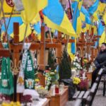 A woman visits a grave of her relative, who was