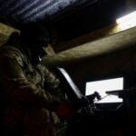 Ukrainian serviceman of an air defence unit checks an FPV-drone