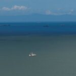 A drone view of a fishing boat anchored in the