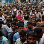 Supporter of Bangladesh Nationalist Party (BNP) holds a picture of