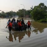 People ride on a boat belonging to Sri Lanka army