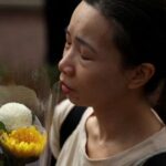 Flower tributes for victims of the deadly fire near the