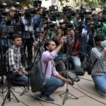 Members of media work outside a court on the day