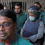 Police officers escort former Rajdhani Unnayan Kartripakkha (RAJUK) member Mohammad