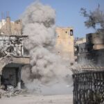 Smoke rises after a landmine exploded as fighters of Syrian