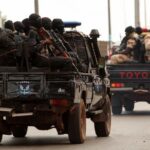 Soldiers patrol on the main road in Bissau