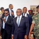 Sierra Leone’s President Julius Maada Bio, who chairs ECOWAS, walks