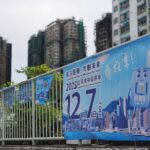 Posters for the upcoming legislative council election near the fire-damaged