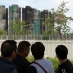 People stand near the Wang Fuk Court housing complex in