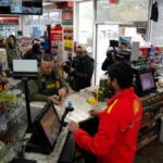 A Border Patrol agent buys goods at gas station in