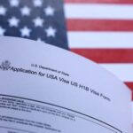 Illustration shows U.S. flag and U.S. H-1B Visa application form