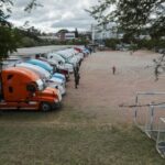 Members of security forces guard trucks holding ballot boxes, in